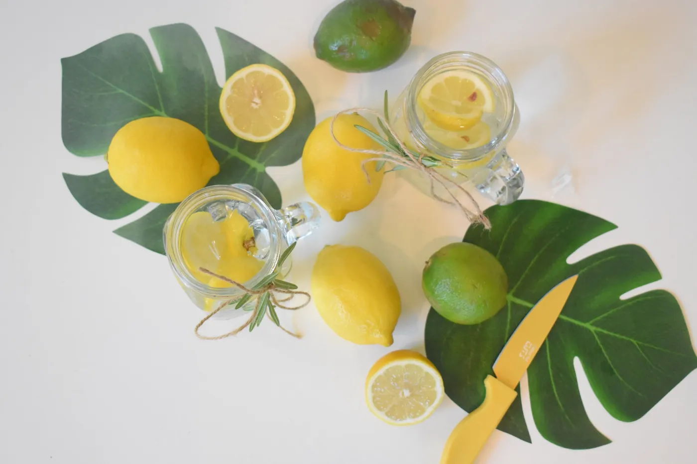 Lemons, limes and rosemary lemonade in mason jars