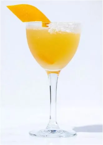 A frozen mango margarita with a sugared rim